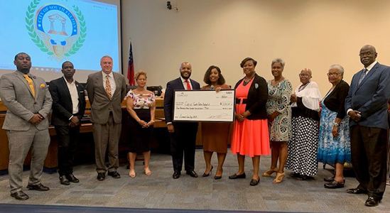 Comcast delivers the City of South Fulton a check. 