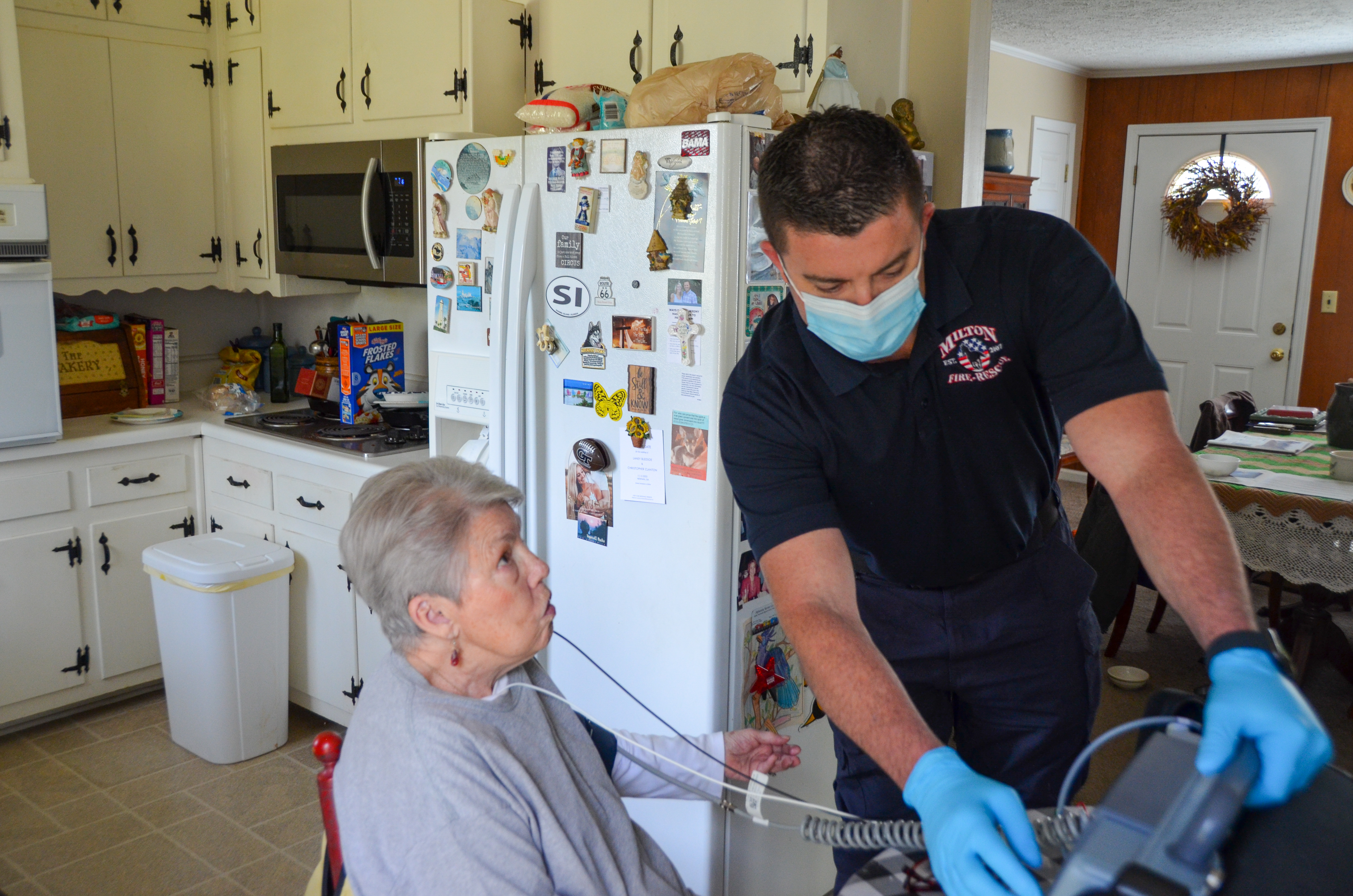 A member of the Milton's C.A.R.E.S. team visits a patient in her home. 